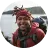 Reviewer photo of a smiling person in a red cap and jacket